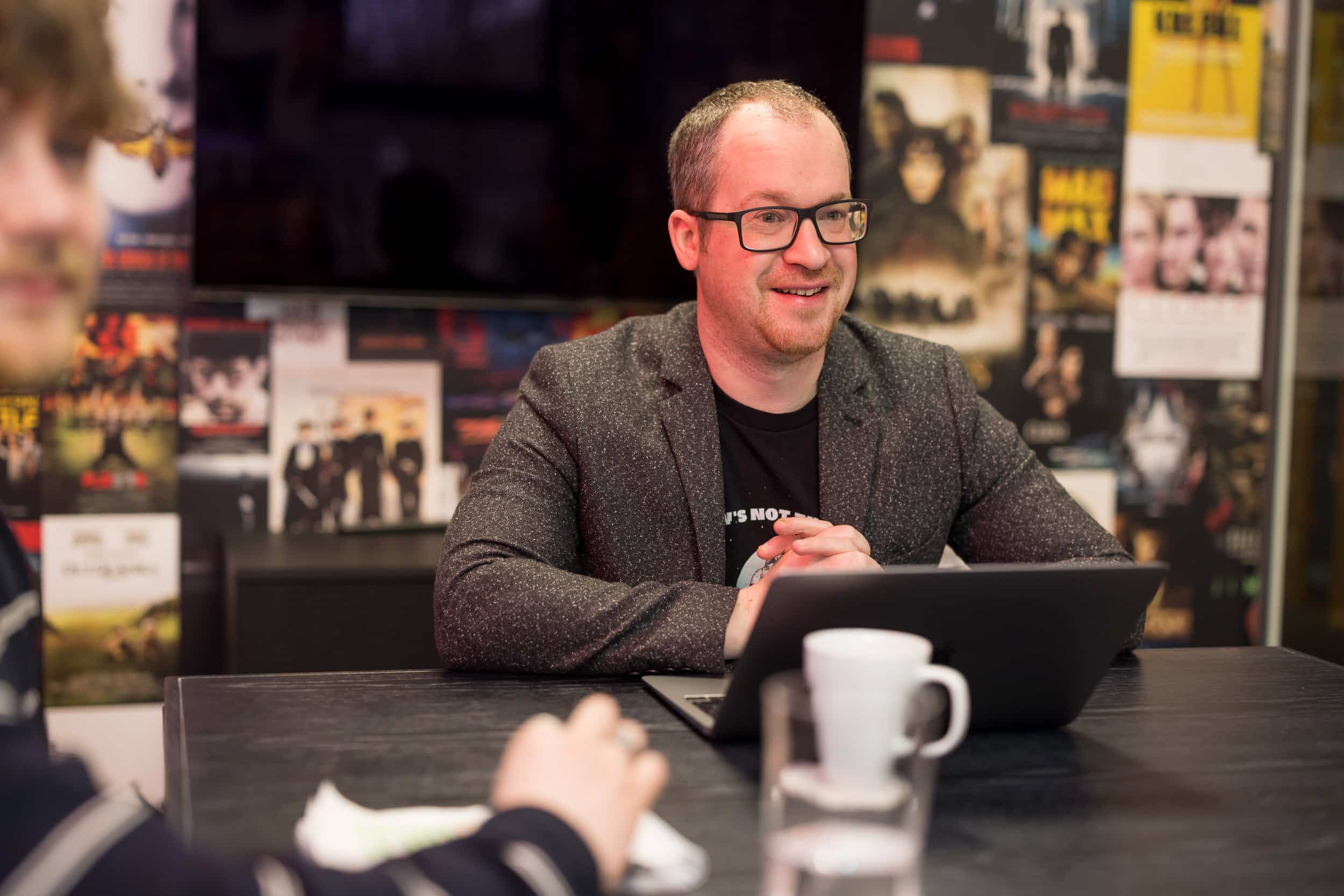 Creative director leading production meeting at Shot Blast Media office in Leeds