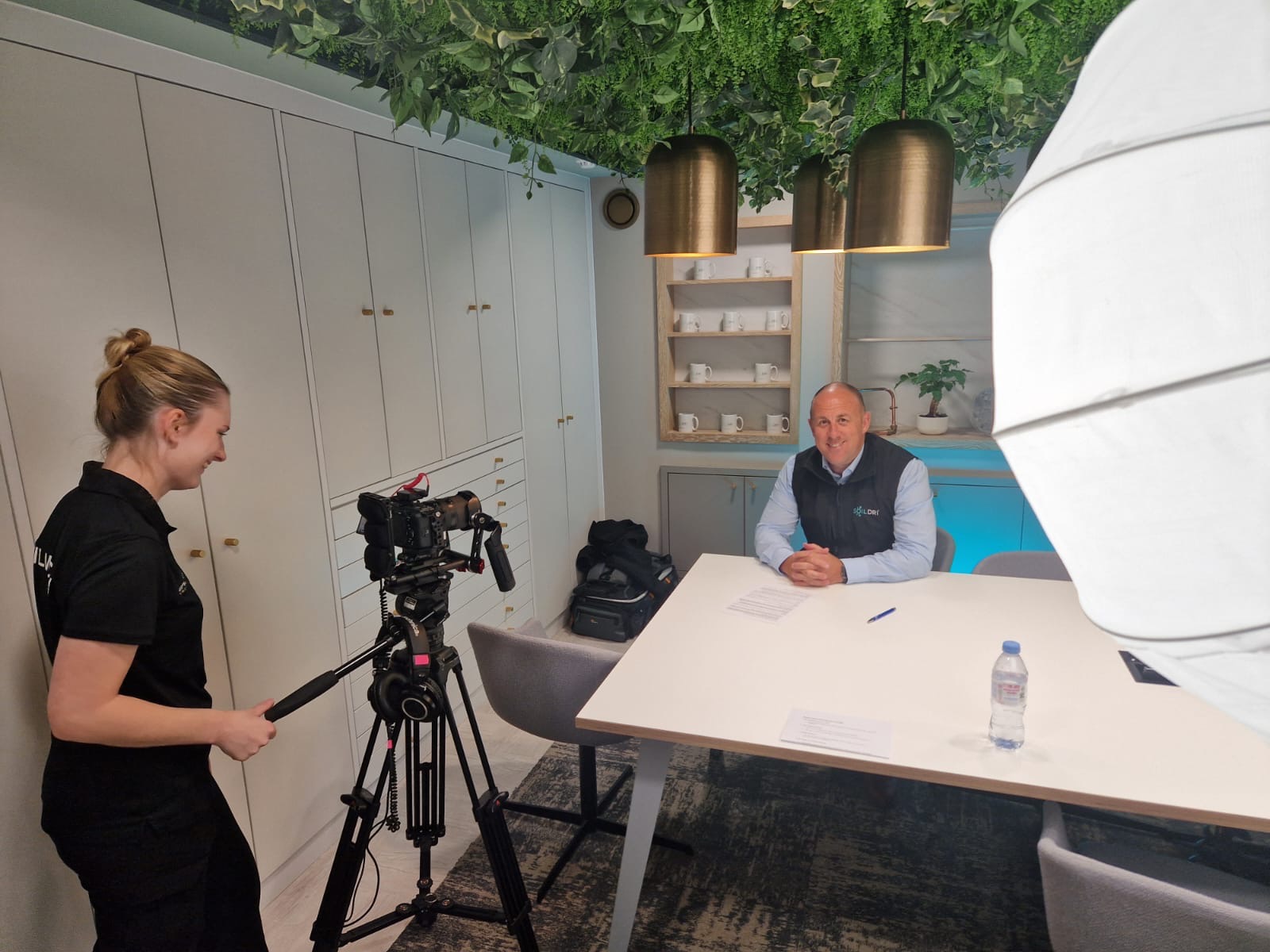Filming corporate interview on set — freelance videographer and camera operator opportunities